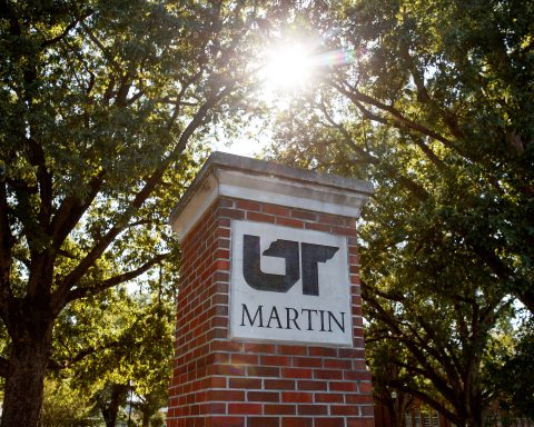 A UT Martin post is shown under trees and a sunny sky.